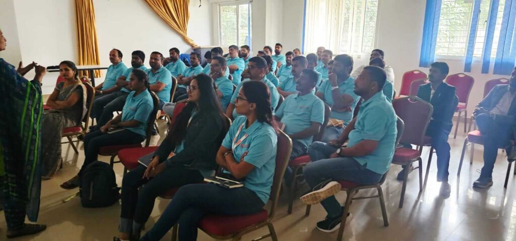 Corporate team attending bilingual PoSH training session for workplace safety.